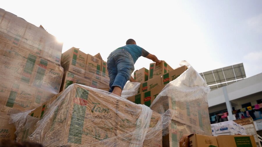 Workers unload WFP food and other humanitarian relief at a school serving as an emergency shelter for thousands of displaced people in Gaza. The supplies are only a fraction of what's needed. Photo: WFP