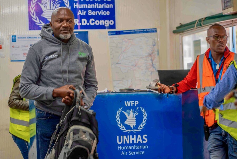 Alphonse Kizitu checks in for a UNHAS flight to Kirumba in DRC's North Kivu province—allowing him to avoid a long and dangerous land voyage. Photo: WFP/Benjamin Anguandia