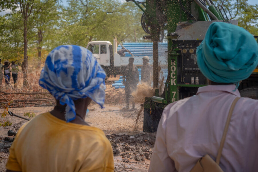 Villagers in Zimbabwe watch the construction of a WFP-supported borehole to help tide them through one of the country's worst droughts in decades. Photo: WFP/KB Mpofu