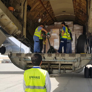 United Nation Human Air Support staff offloading humanitarian support to frontlines in crises.