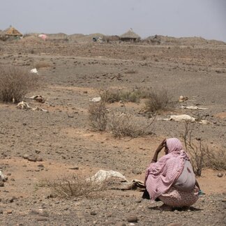 Woman watching her arid land caused by drought in Somali region in Ethiopia