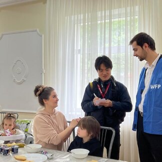 Woman and her children receiving hot meals in reception centres in Moldova supported by WFP